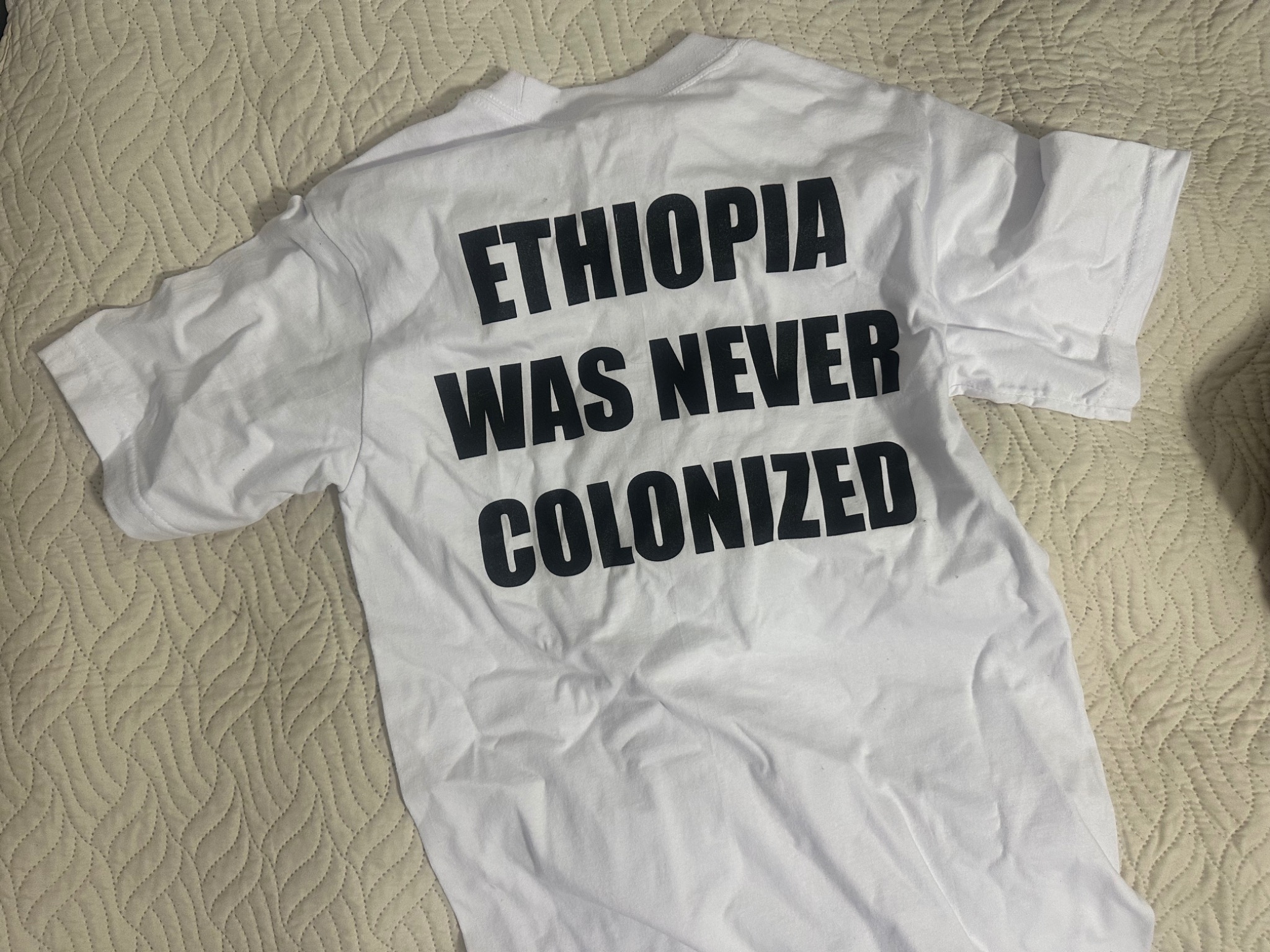 Back of Interstitium Studio Collection 001 shirt reading Ethiopia Was Never Colonized